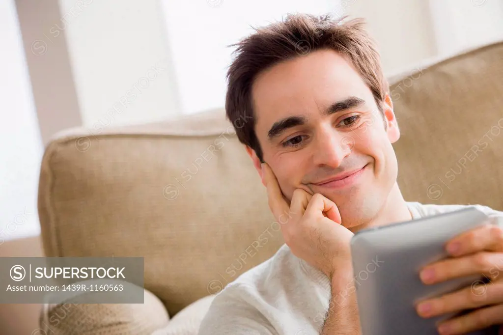 Mid adult man holding electronic reader