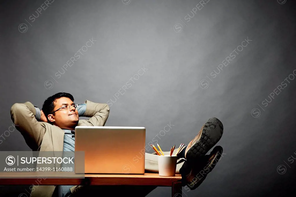 Man relaxing with feet up on table