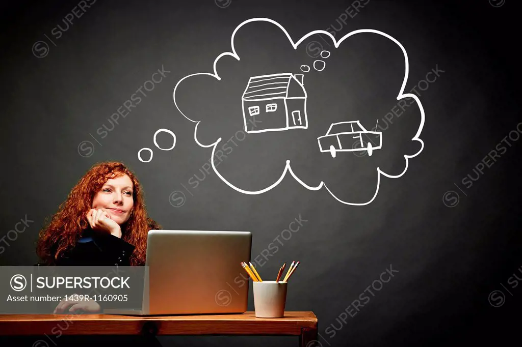 Woman dreaming of new house and car