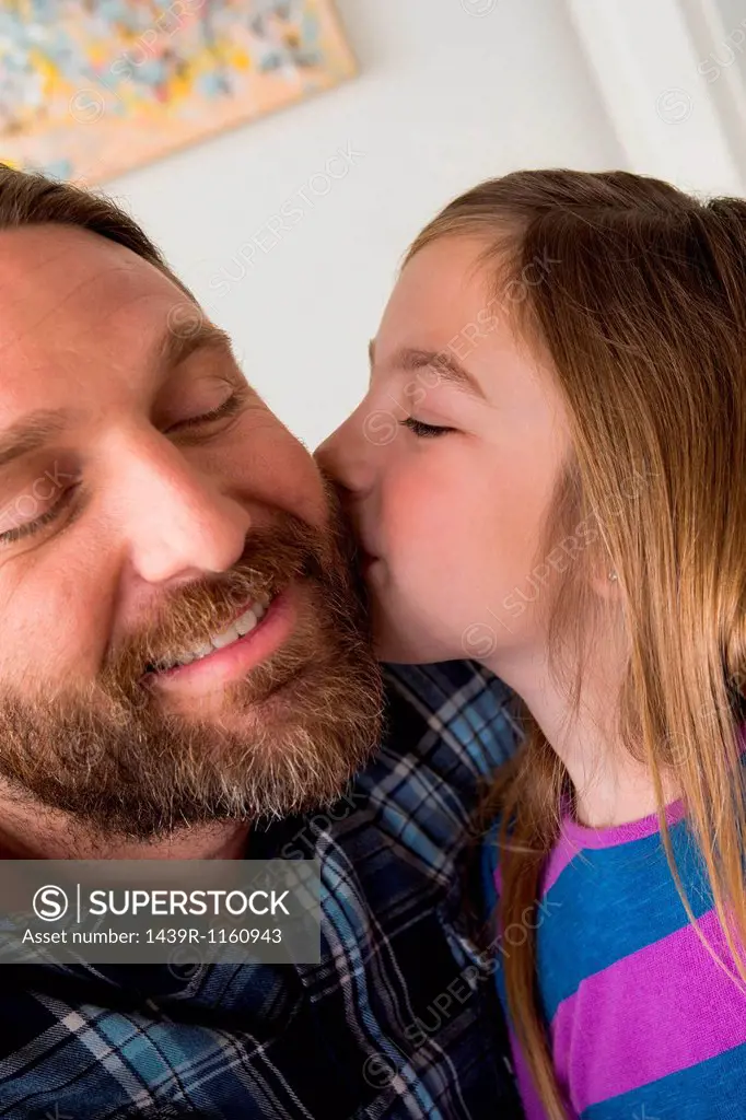 Daughter kissing father´s cheek