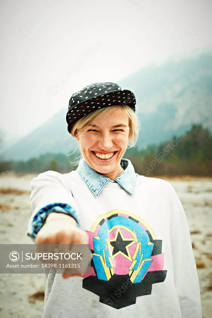 Woman holding hand out and smiling