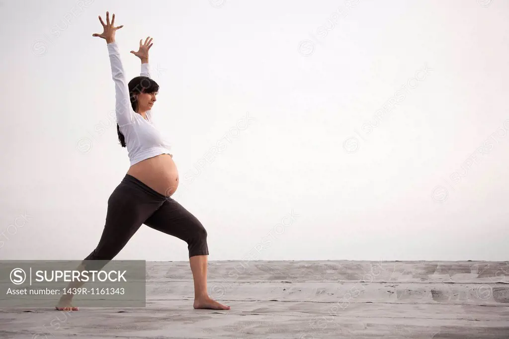Pregnant woman in yoga warrior pose