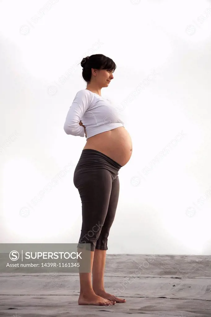 Pregnant woman in yoga mountain pose