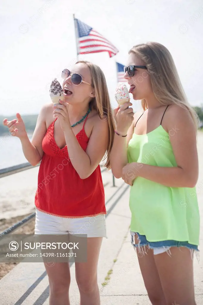 Young women eating ice cream at beach