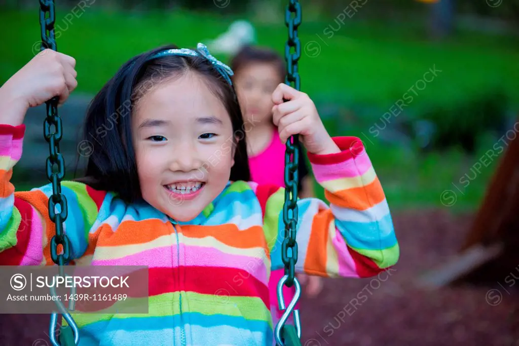 Girl wearing striped top on swing