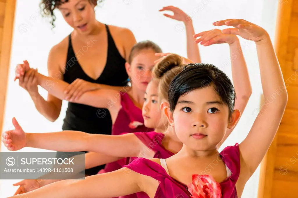 Ballerinas practising with ballet teacher