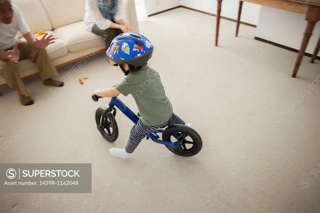 Boy learning to ride bicycle, high angle