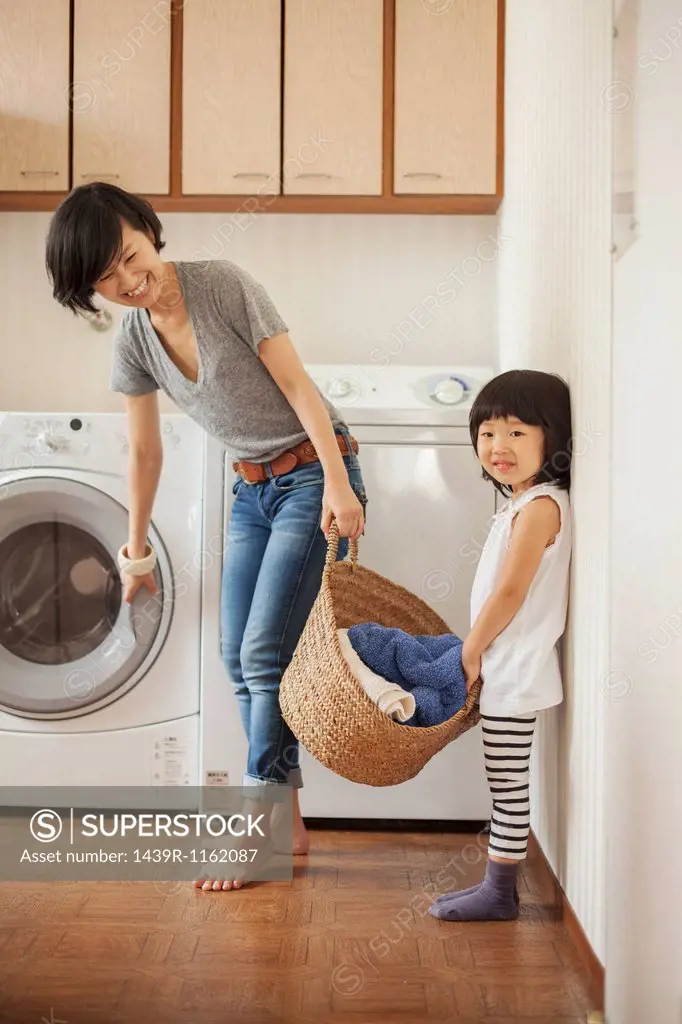 Mother and daughter with laundry basket
