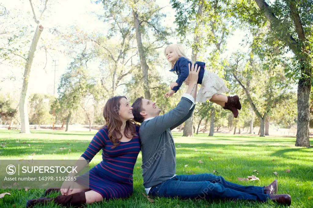 Young parents in park with female toddler
