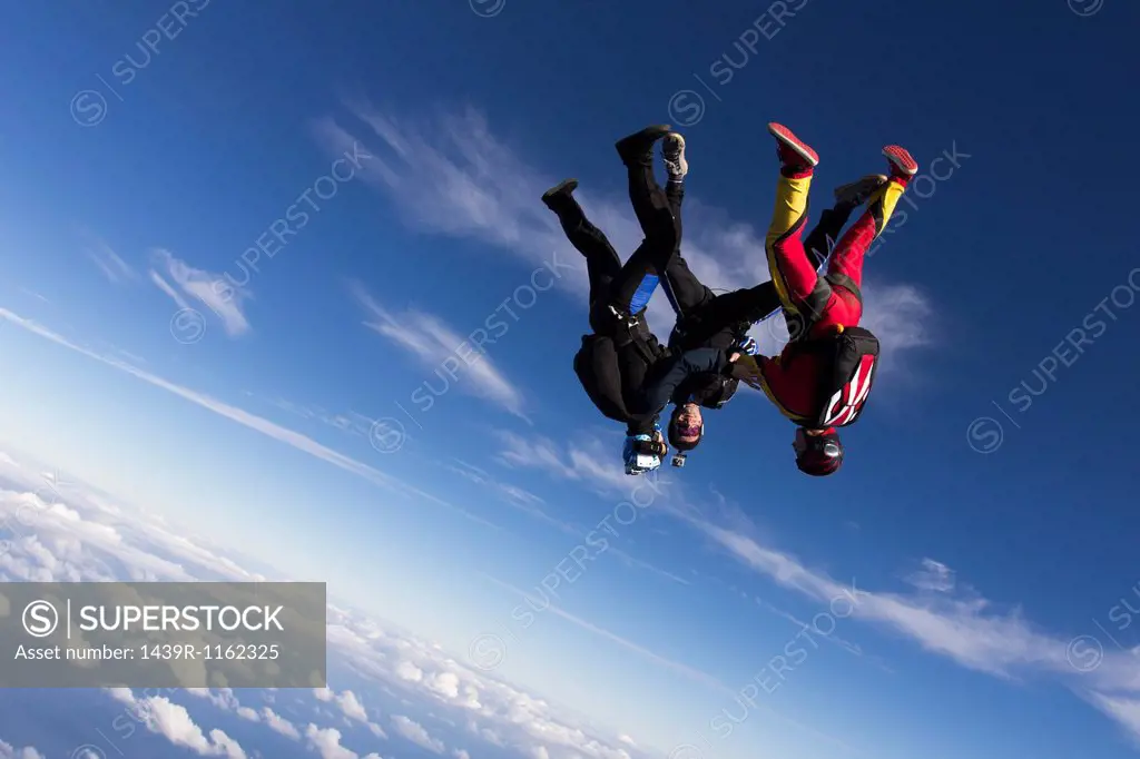 Formation skydivers free falling upside down