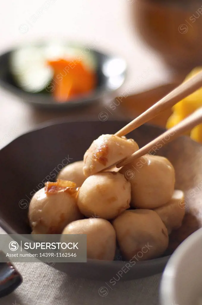 Still life of chopsticks picking up japanese dumpling