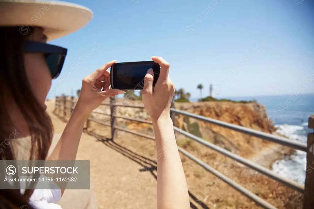 Young woman photographing view, Palos Verdes, California, USA