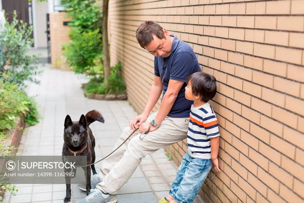 Father and young son with dog