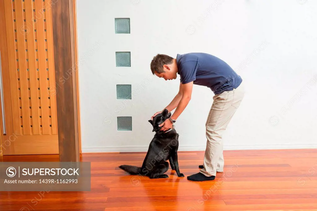 Man stroking his pet dog