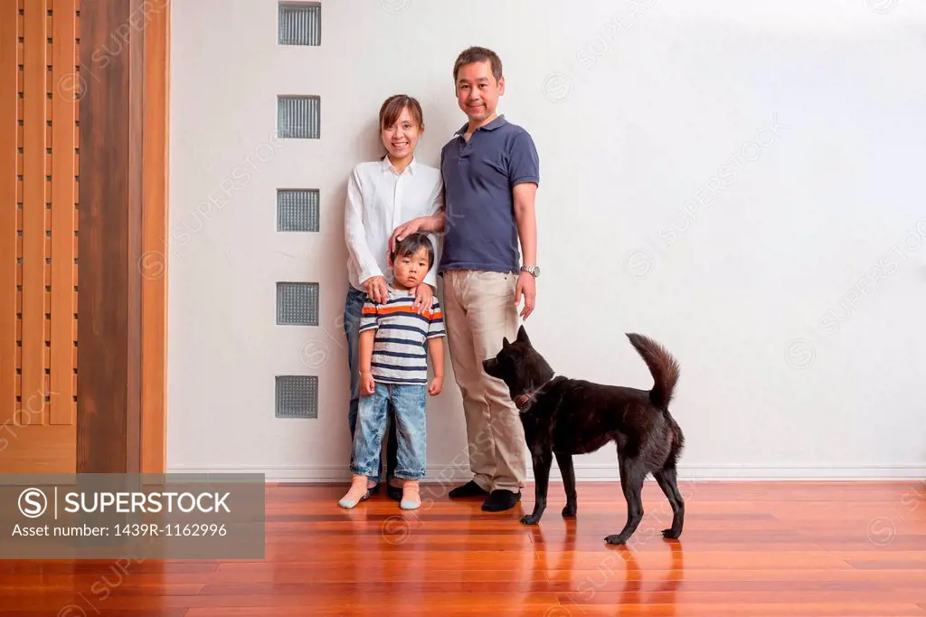 Family with young son and pet dog