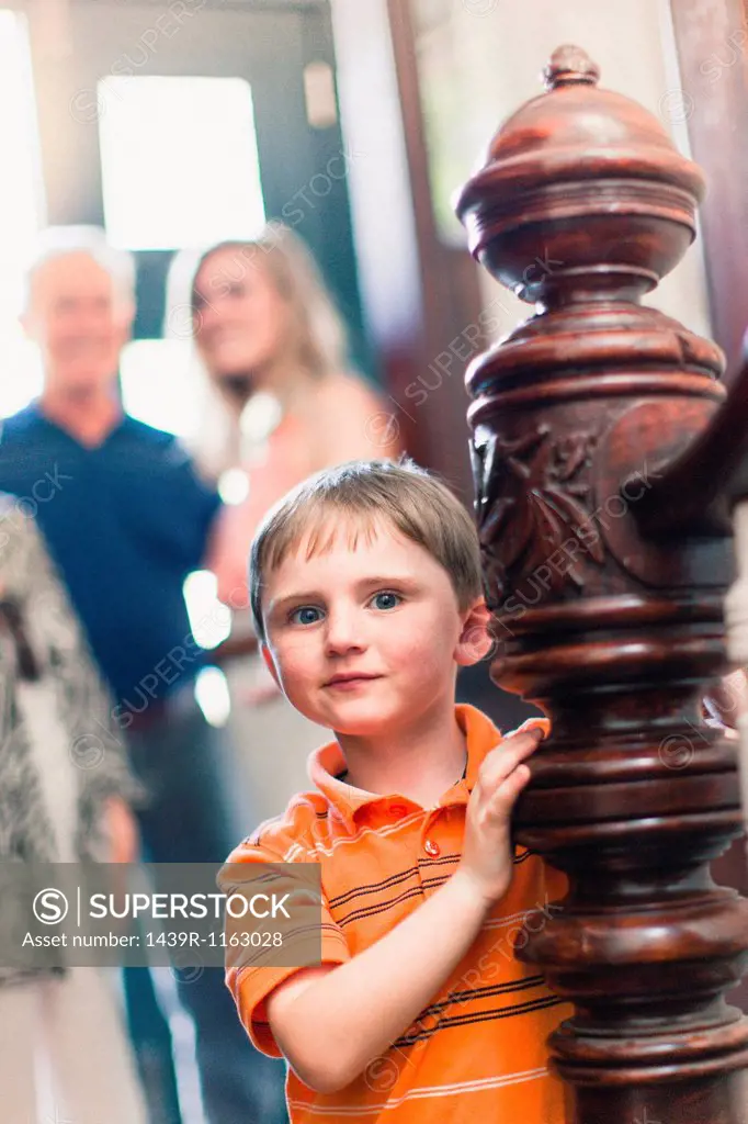 Portrait of boy by wooden banister