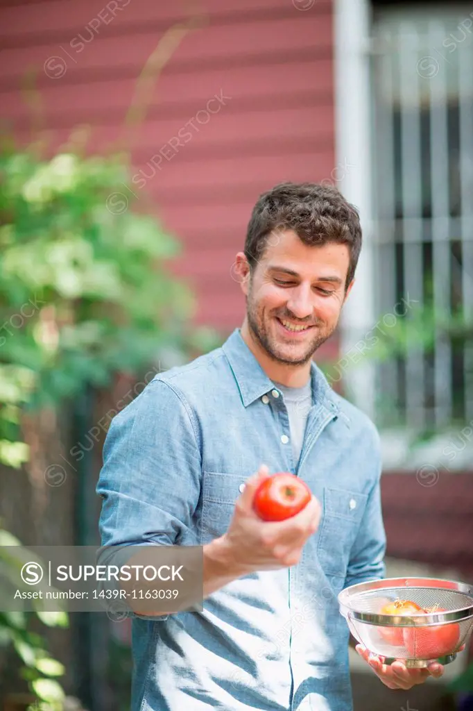 Portrait of man holding apple