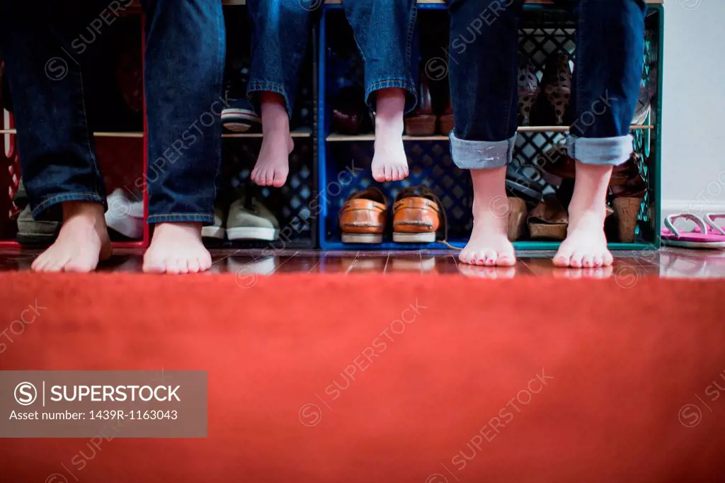 Child and parents with bare feet, low section