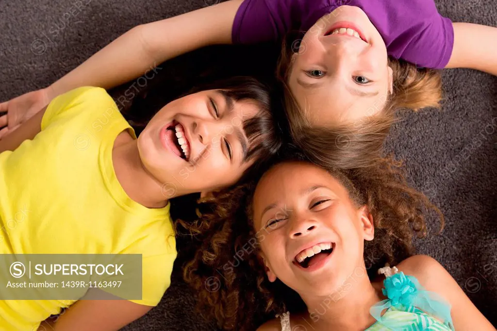 Three girls laughing, overhead view