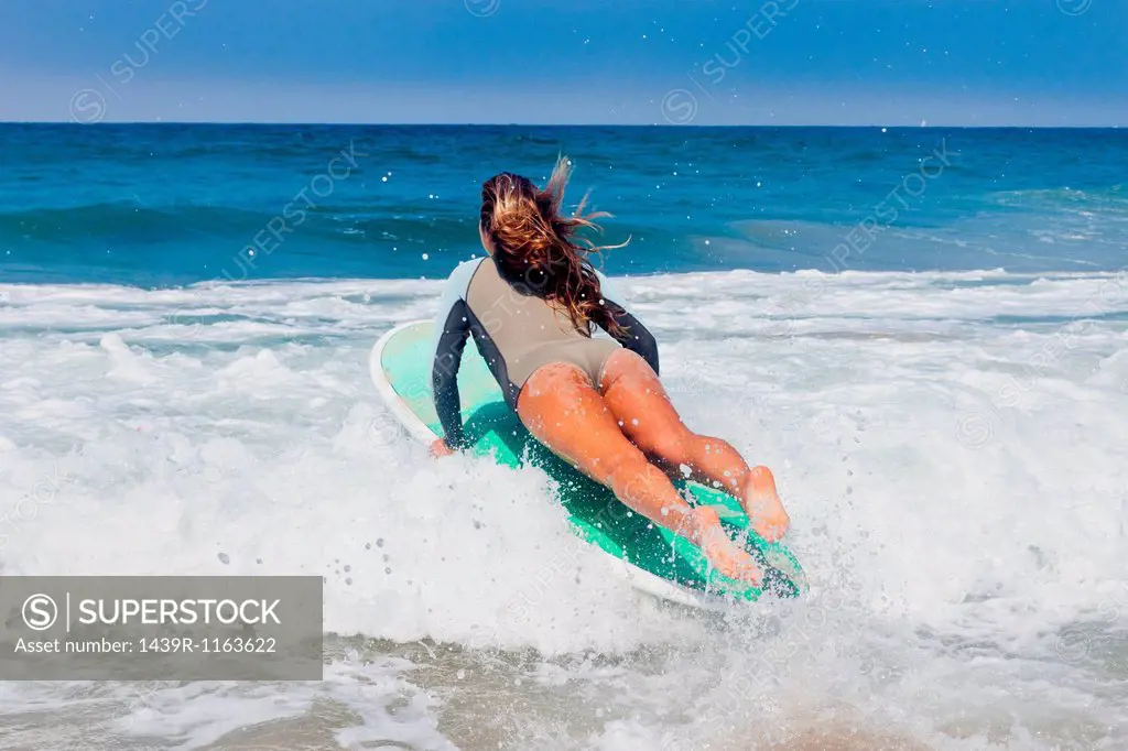Young woman surfing, Hermosa Beach, California, USA