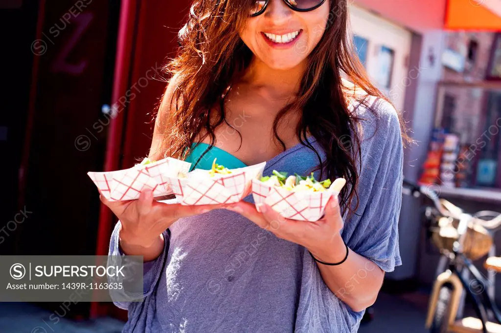 Woman with takeaway food, Hermosa Beach, California, USA