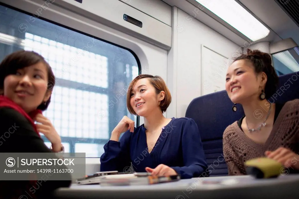 Young women talking on train