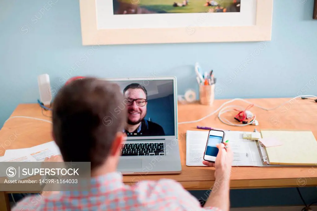 Man sitting at desk making video call