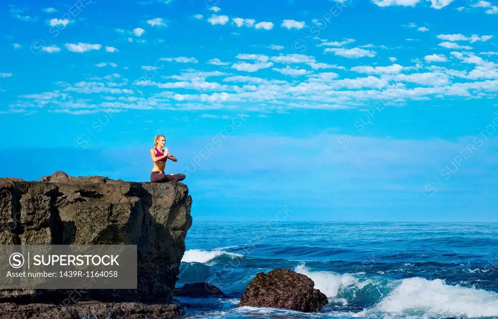 Woman doing yoga at coast