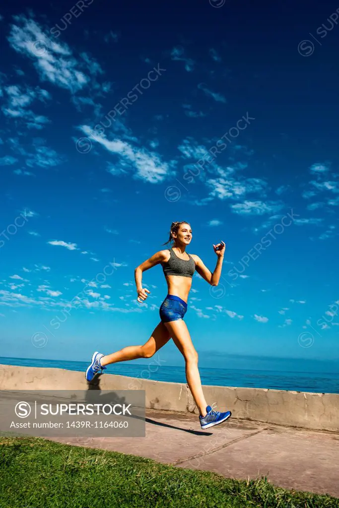 Woman running at coast