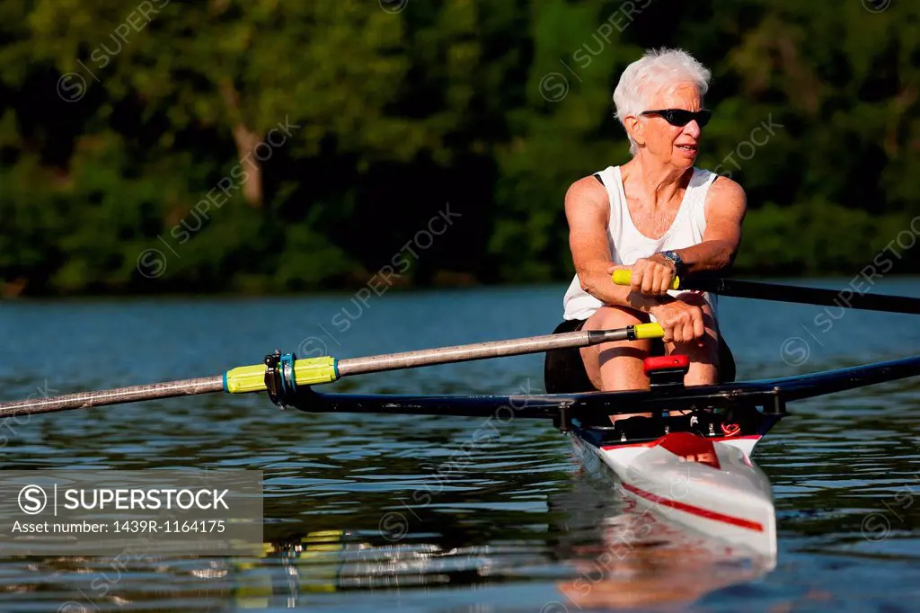 Senior woman rowing in rowing boat