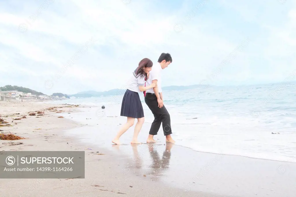 Young couple fooling around on beach