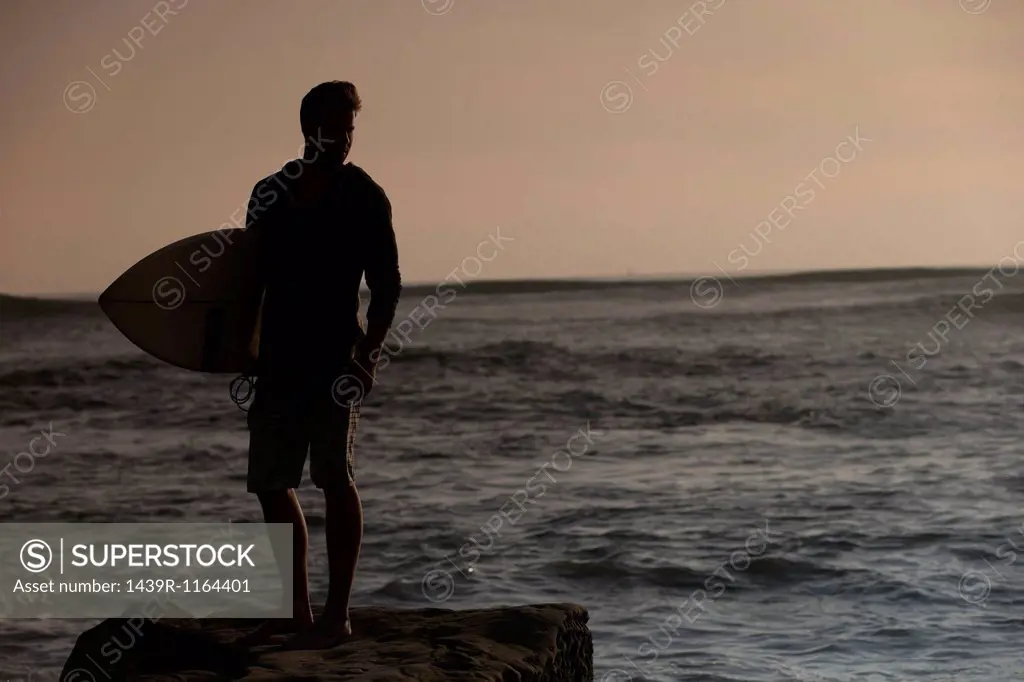 Silhouette of young male surfer, San Diego, California, USA