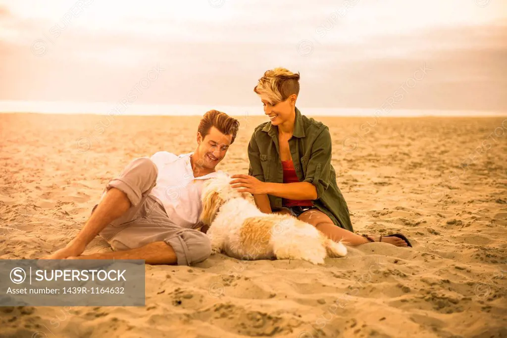 Young couple on Mission Beach with dog, San Diego, California, USA