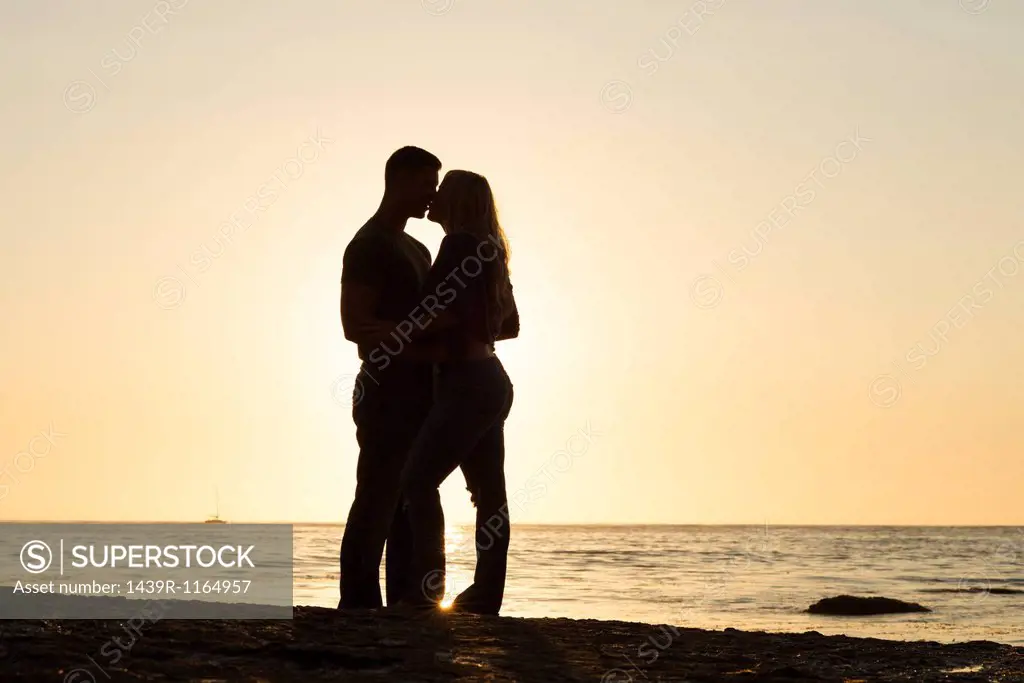 Silhouette of young couple kissing, Sunset Cliffs, San Diego, California, USA