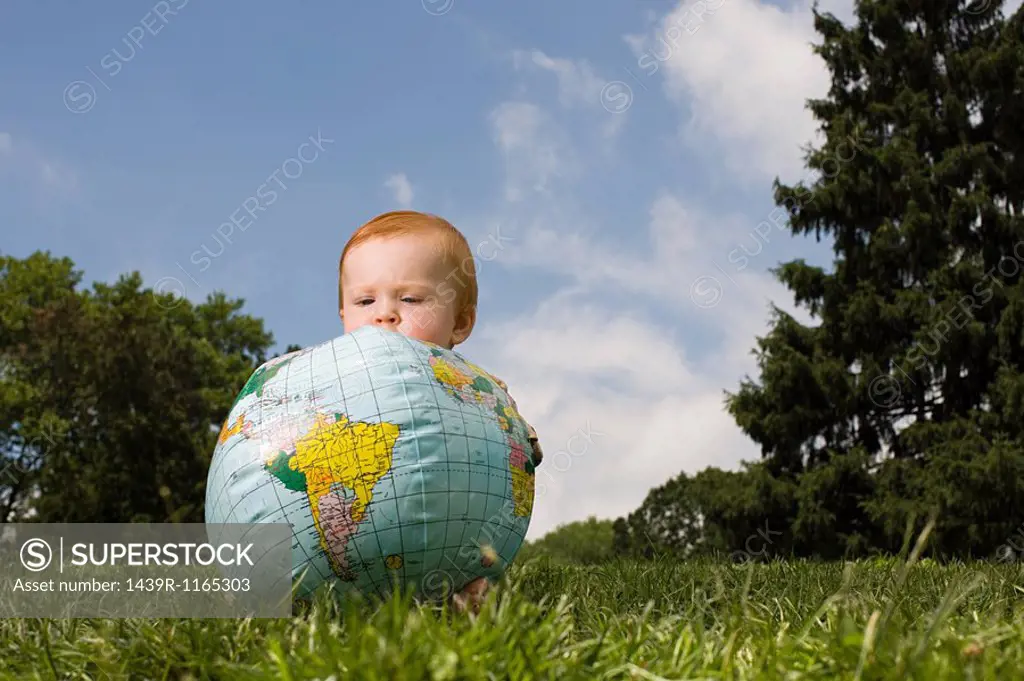 Baby with inflatable globe