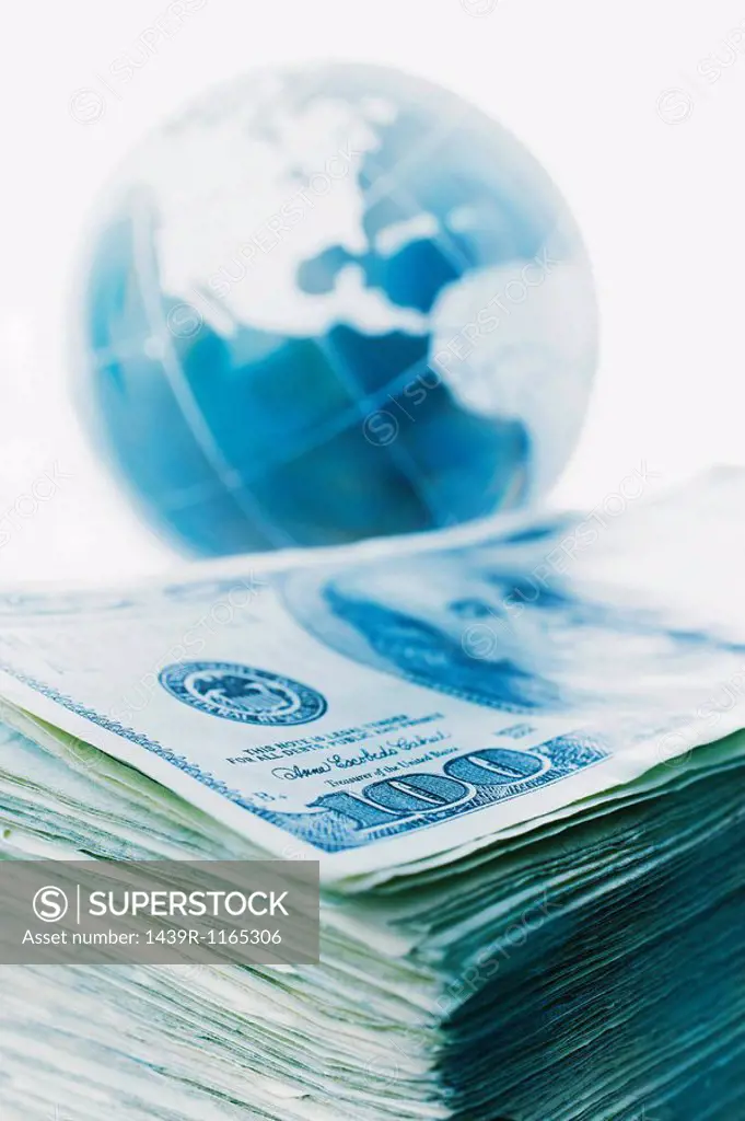 Stack of banknotes and globe