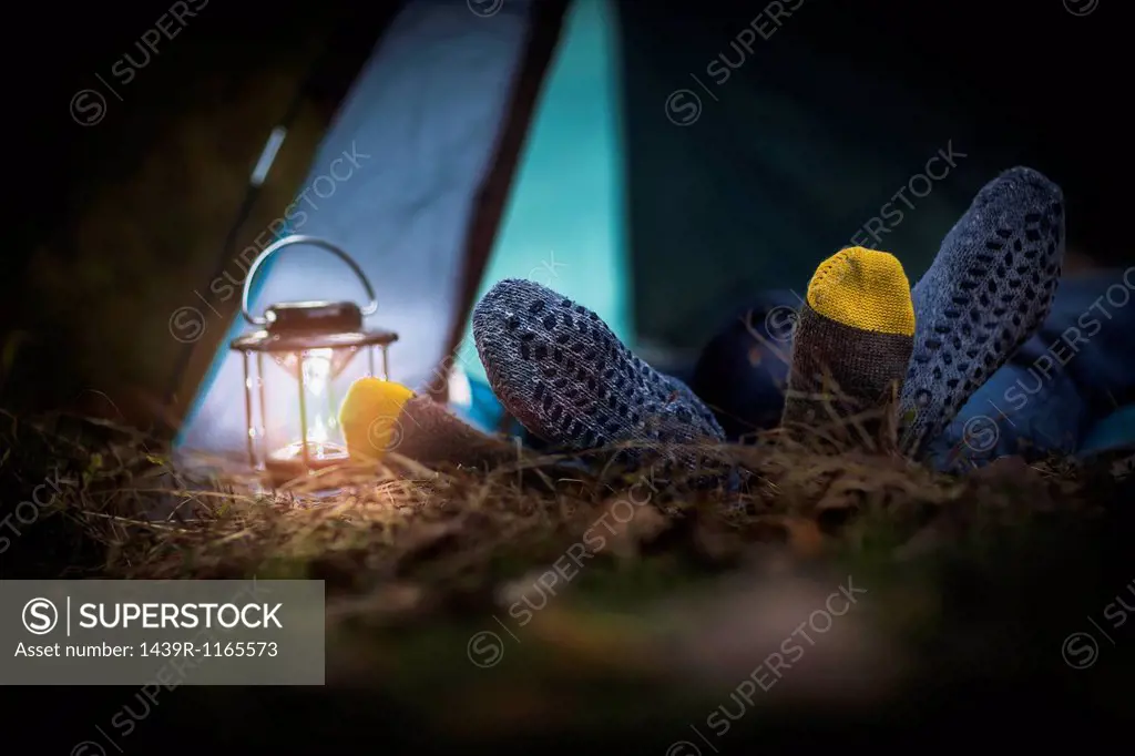 Couple lying in tent - feet together