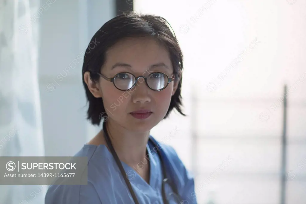 Portrait of young female doctor in office