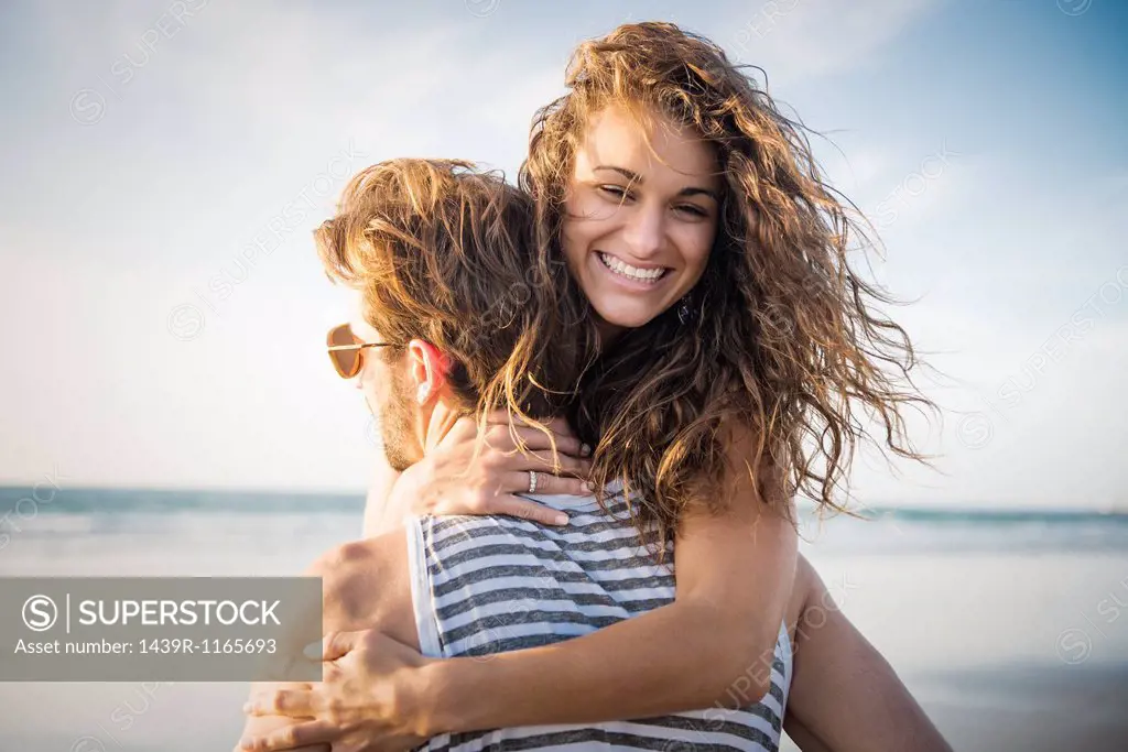 Young couple hugging in San Diego beach