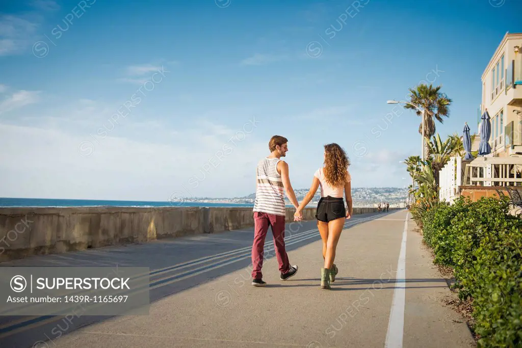 Young couple walking at San Diego beach