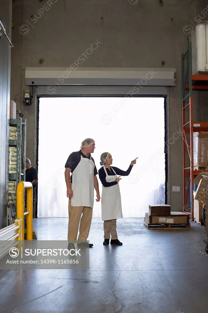 Factory workers in storage warehouse
