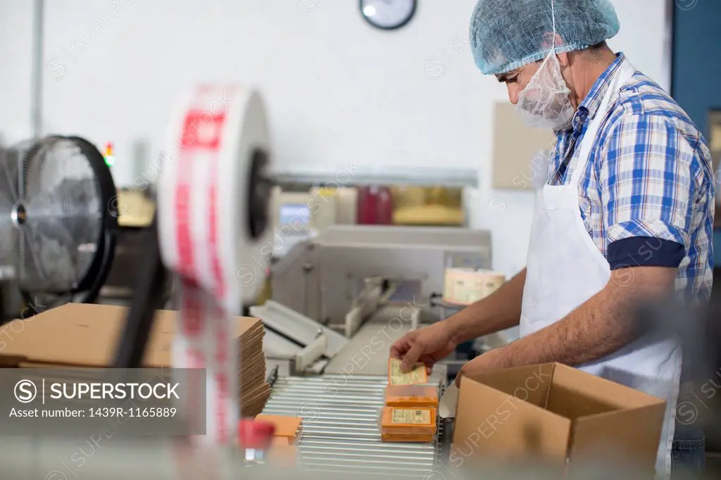 Man packaging vegan cheese in warehouse