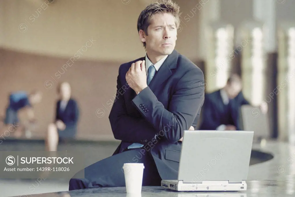 Businessman outside with laptop 