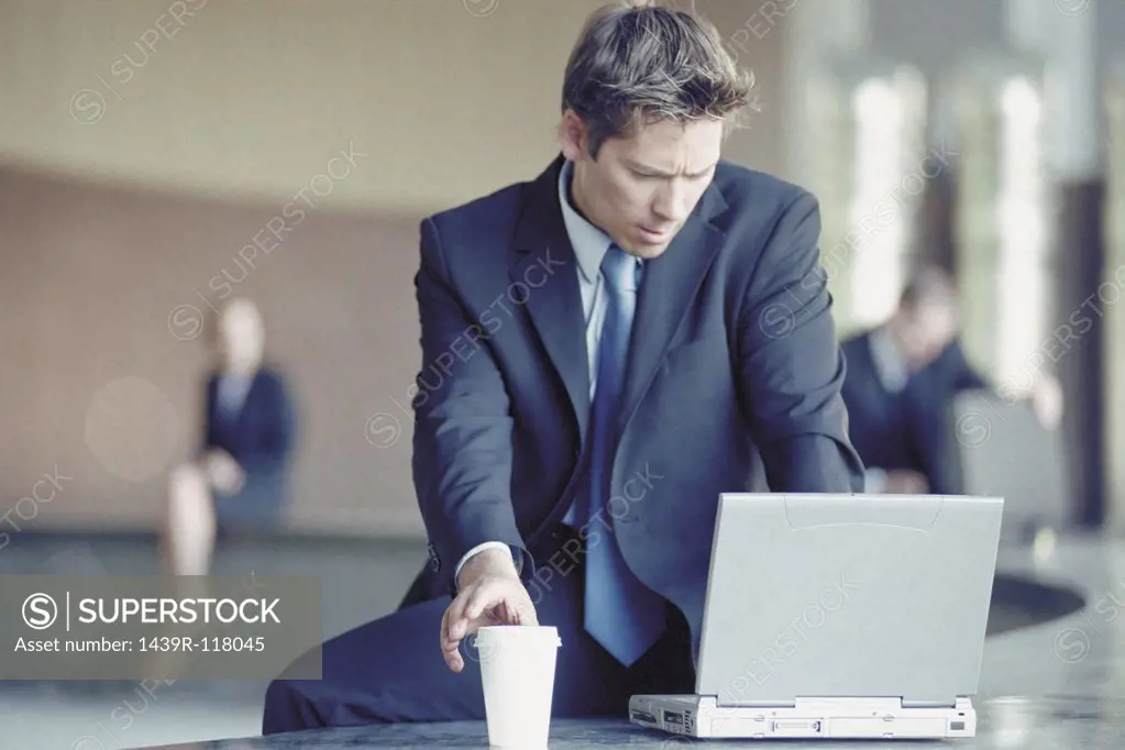 Businessman outside with laptop 