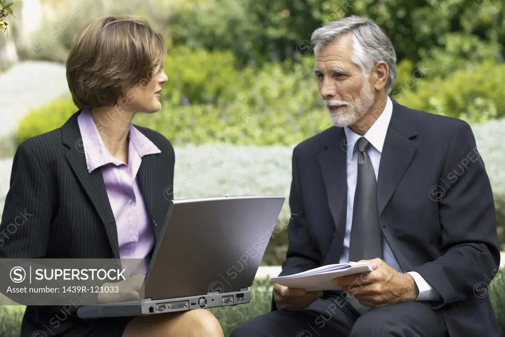 Businessman and businesswoman in a meeting outside