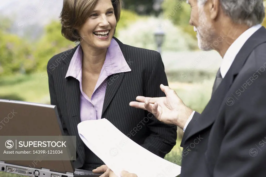 Businessman and businesswoman in a meeting outside