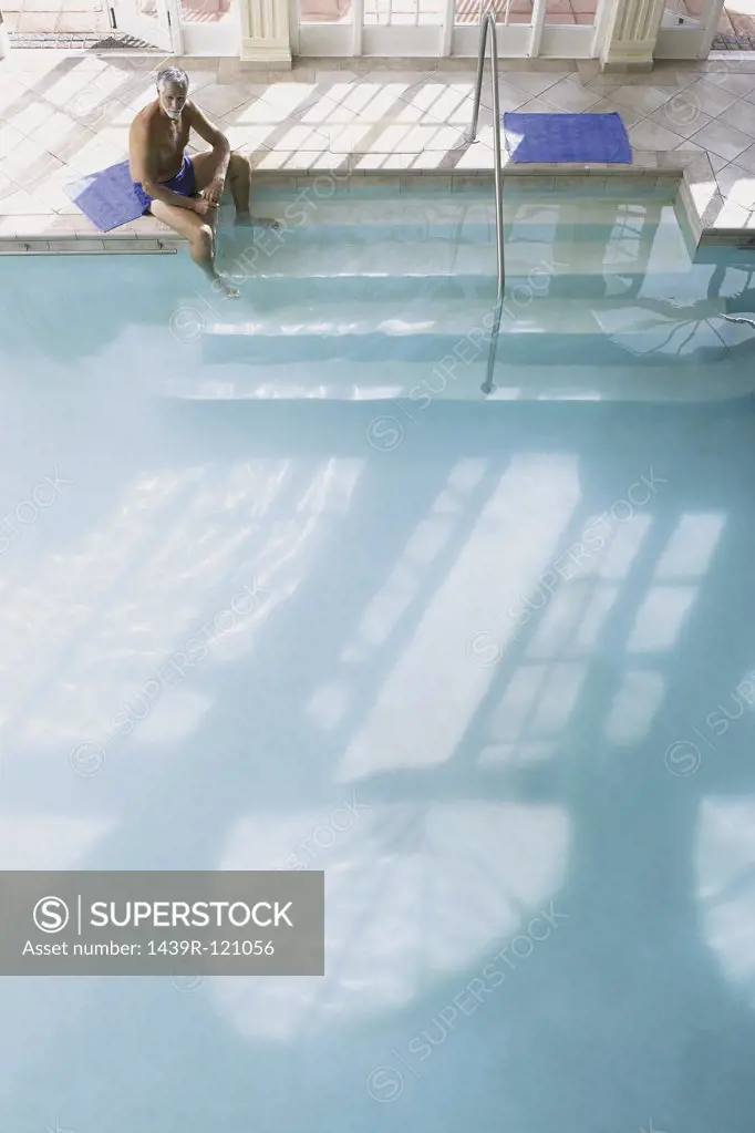 Man on the edge of swimming pool