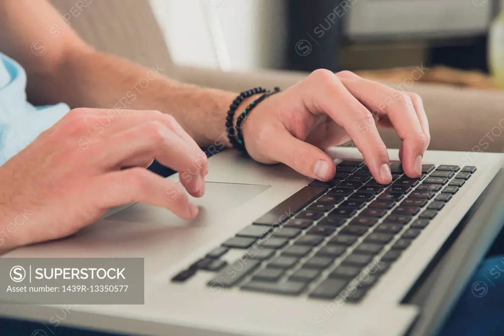 Hands of man using laptop