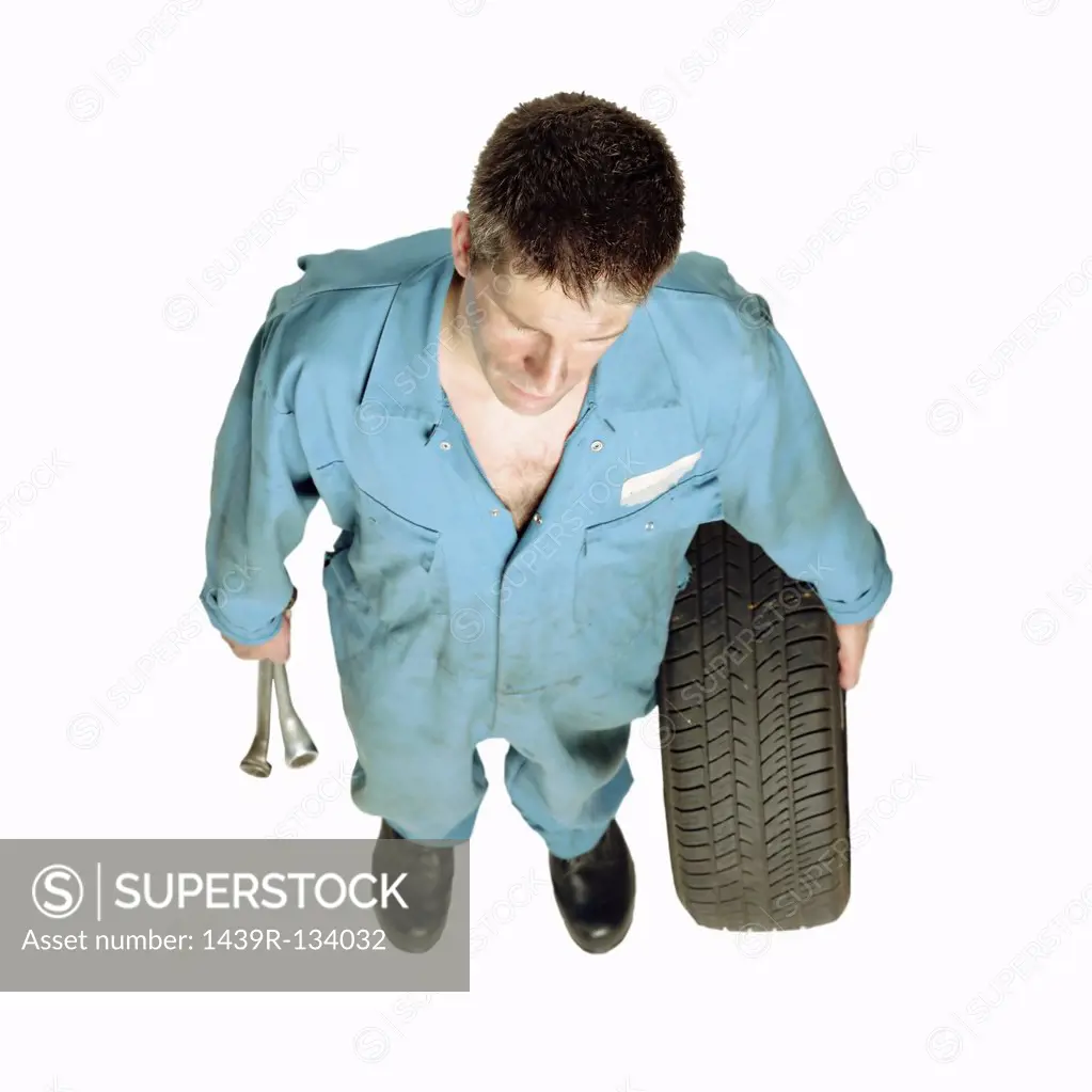 Mechanic holding wheel