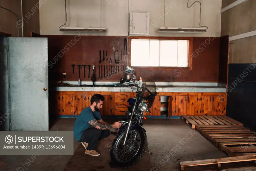 Man repairing bike in workshop